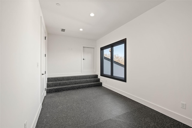 spare room with recessed lighting, visible vents, baseboards, and stairs