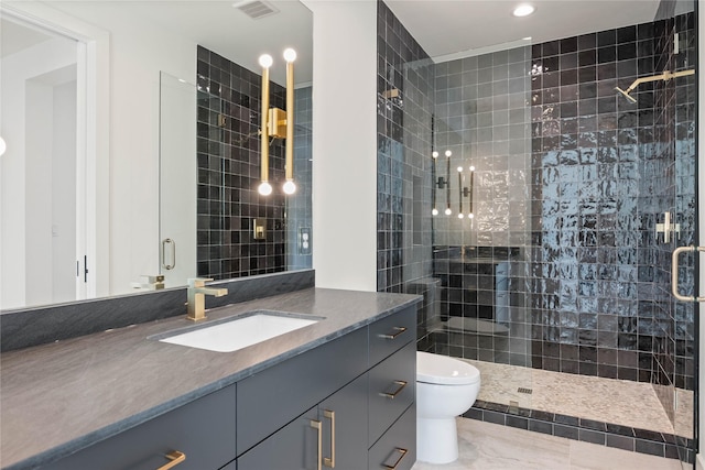 bathroom featuring visible vents, vanity, toilet, and a shower stall