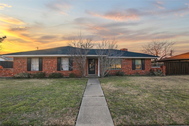 ranch-style home featuring a yard