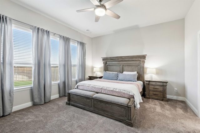 bedroom with visible vents, baseboards, a ceiling fan, and light colored carpet