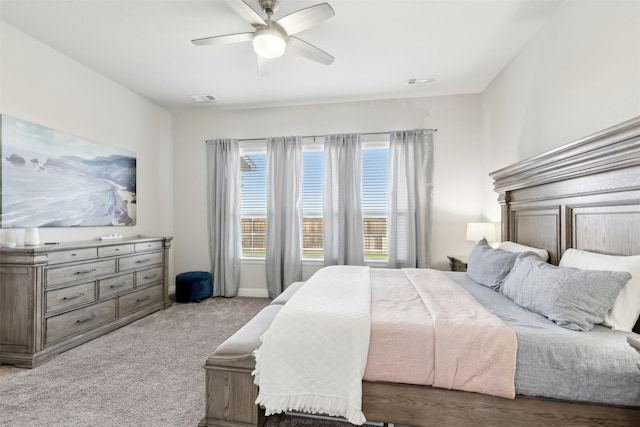 bedroom featuring a ceiling fan, light carpet, visible vents, and baseboards