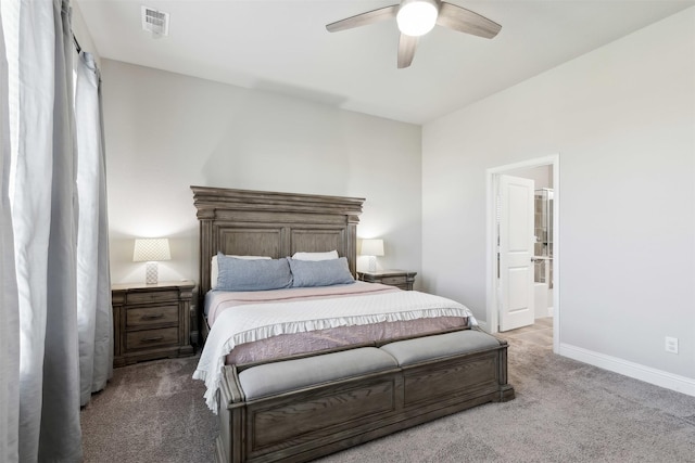 bedroom with visible vents, ensuite bathroom, a ceiling fan, light carpet, and baseboards