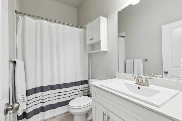 full bathroom featuring toilet and vanity