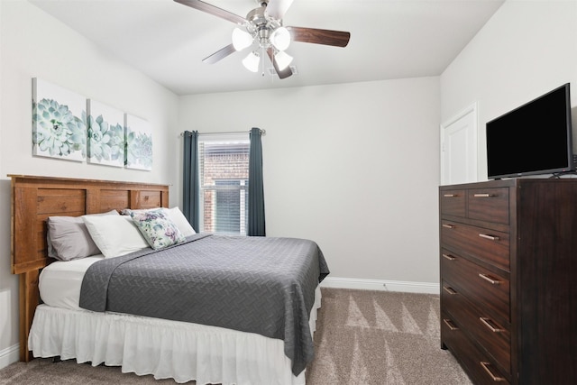 carpeted bedroom featuring a ceiling fan and baseboards