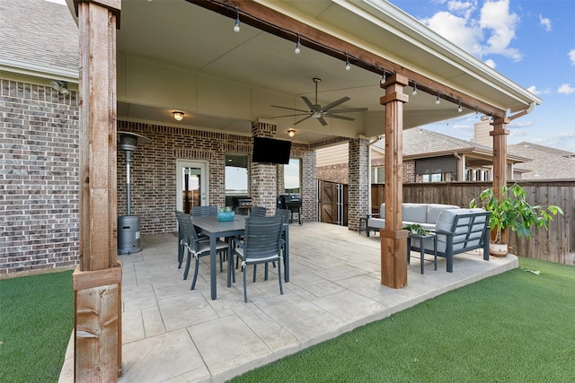 view of patio / terrace featuring outdoor dining space, ceiling fan, an outdoor hangout area, and fence