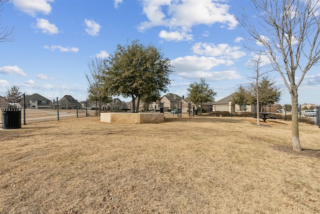 view of yard featuring fence and a residential view