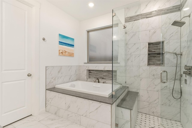 bathroom featuring separate shower and tub