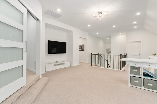 carpeted living room with vaulted ceiling