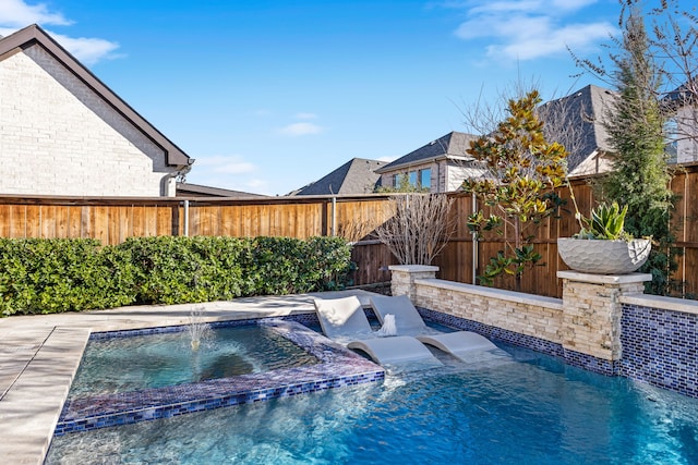 view of pool featuring pool water feature and a hot tub