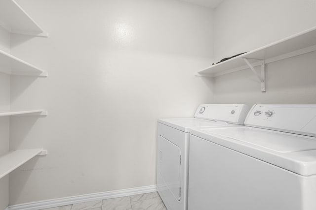 clothes washing area with washer and dryer