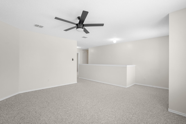 unfurnished room featuring light carpet and ceiling fan