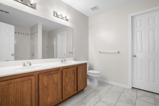 bathroom featuring vanity, toilet, and walk in shower