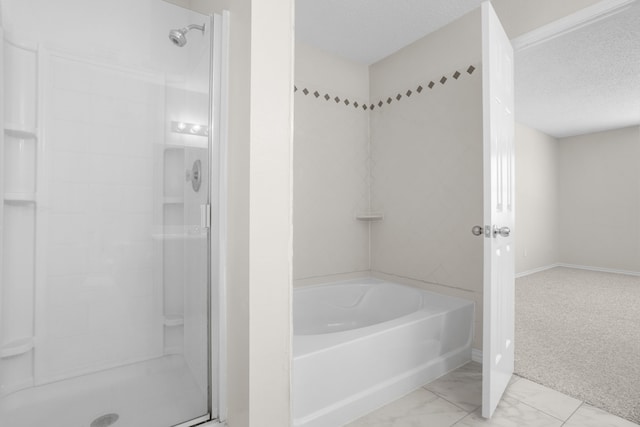 bathroom with independent shower and bath and a textured ceiling