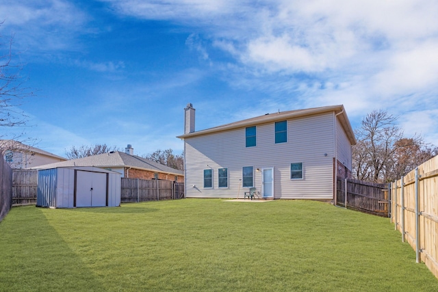 rear view of property with a yard and a storage unit