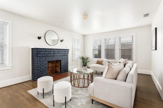 living room featuring wood-type flooring and a fireplace