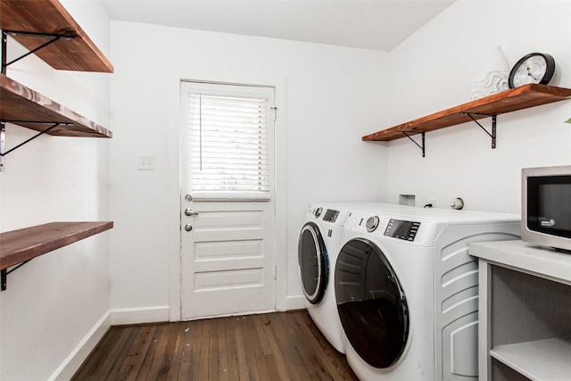 laundry area featuring washer and dryer and dark wood-type flooring