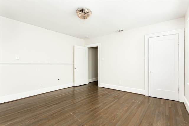 spare room featuring dark hardwood / wood-style floors