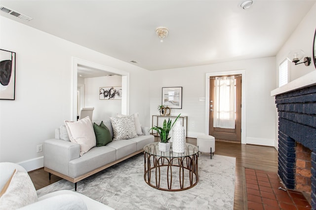 living room with a brick fireplace