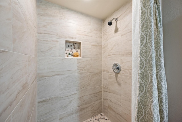 bathroom with a tile shower