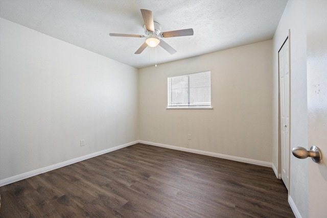 unfurnished room with dark wood-type flooring, a textured ceiling, and ceiling fan