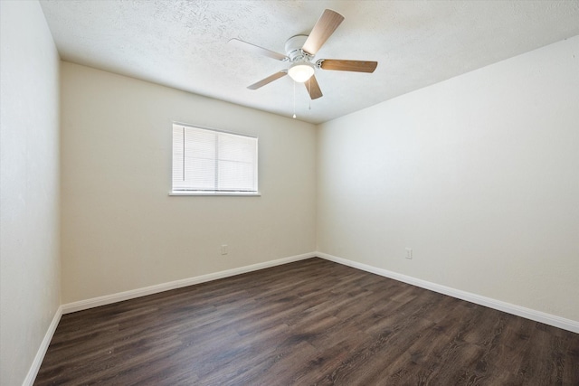 empty room featuring dark wood-type flooring, ceiling fan, and a textured ceiling