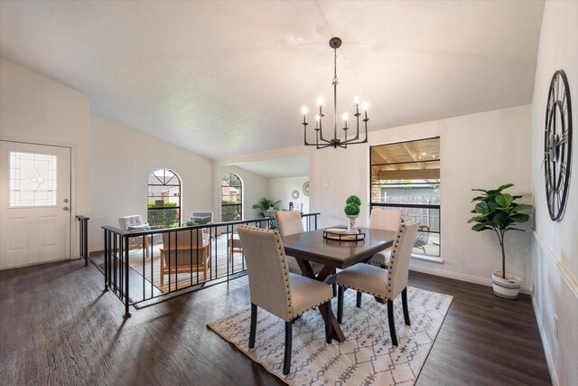 dining space featuring dark hardwood / wood-style floors and an inviting chandelier