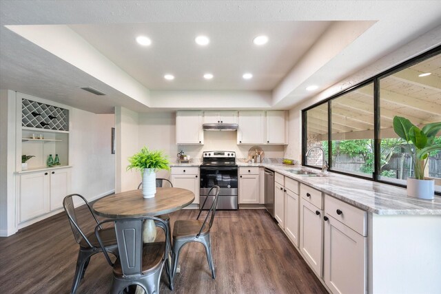 dining area with dark hardwood / wood-style flooring, built in shelves, vaulted ceiling, and a chandelier