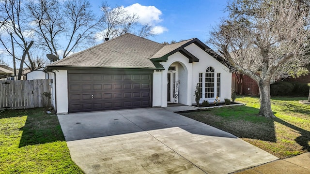 ranch-style home featuring a garage and a front lawn