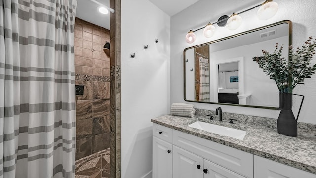 bathroom featuring vanity and a shower with shower curtain