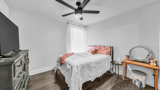 bedroom with dark wood-type flooring and ceiling fan