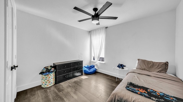 bedroom featuring ceiling fan and dark hardwood / wood-style floors