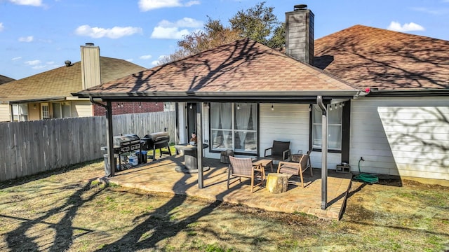 rear view of property with a patio area and a lawn