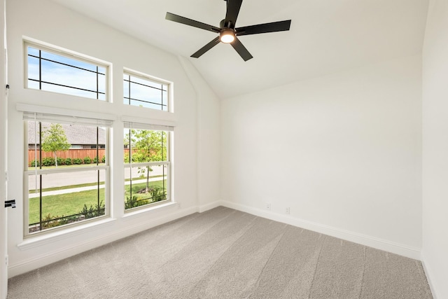 carpeted empty room with baseboards, a ceiling fan, and high vaulted ceiling