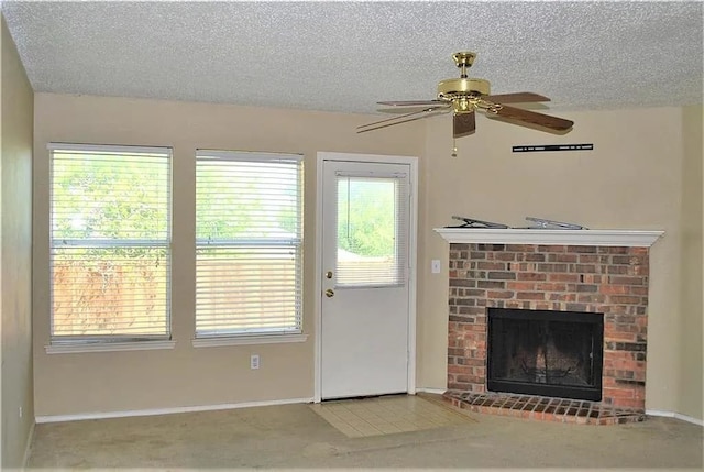 unfurnished living room with ceiling fan, carpet, a textured ceiling, and a fireplace