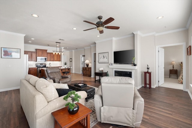 living room with ornamental molding and dark hardwood / wood-style floors