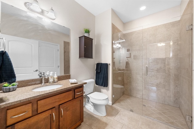 bathroom with tile patterned floors, vanity, toilet, and an enclosed shower