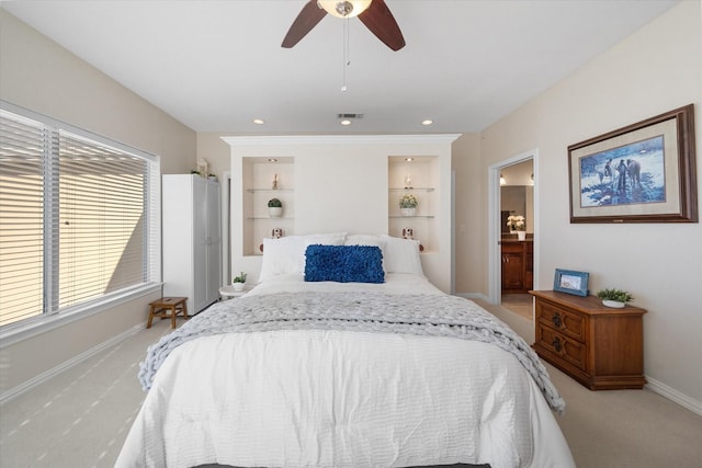 bedroom featuring ensuite bath, carpet floors, and ceiling fan