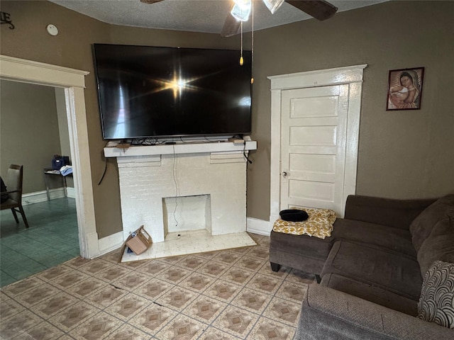 living room featuring ceiling fan and a textured ceiling