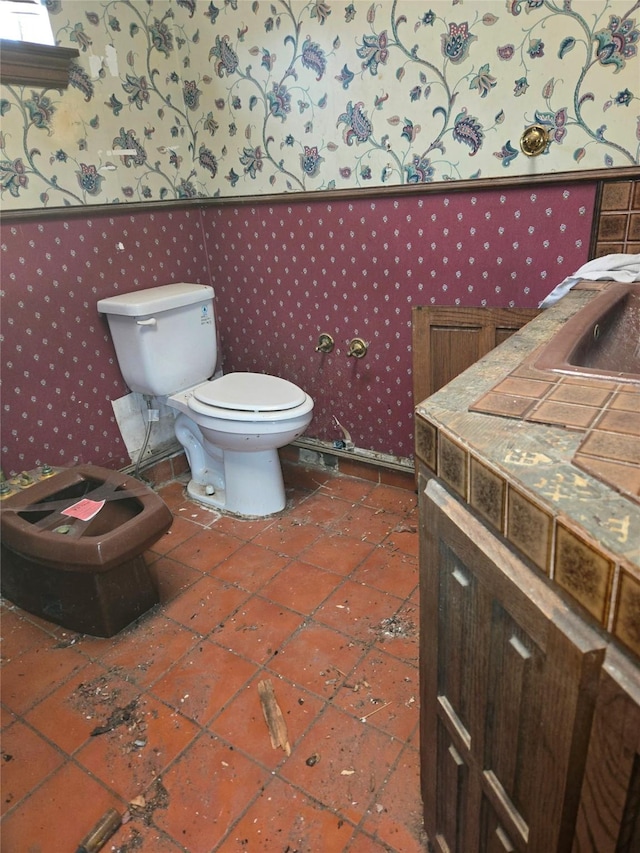 bathroom with toilet and tile patterned flooring