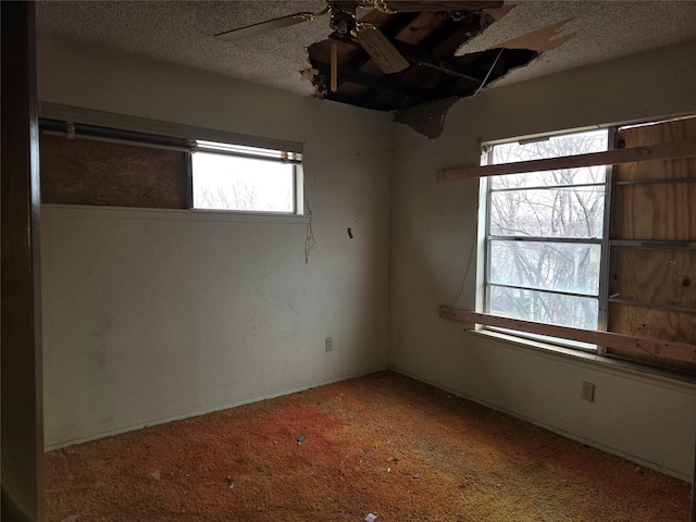 spare room with ceiling fan and a textured ceiling