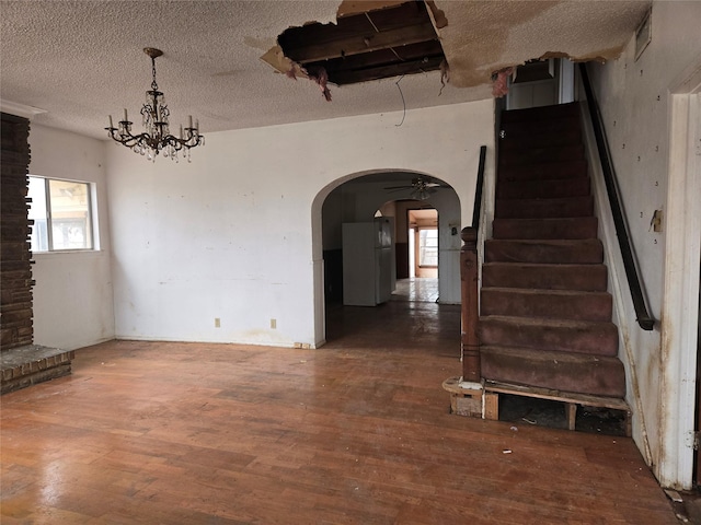 interior space featuring a textured ceiling, dark hardwood / wood-style floors, and a healthy amount of sunlight