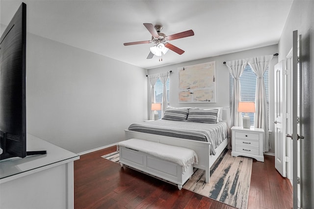 bedroom with ceiling fan and dark hardwood / wood-style floors