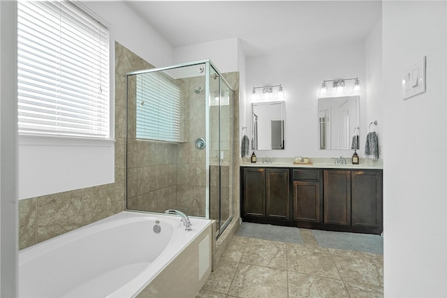 bathroom featuring vanity and independent shower and bath