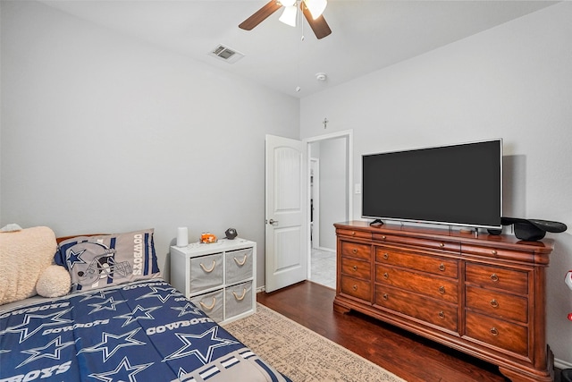 bedroom with dark hardwood / wood-style floors and ceiling fan