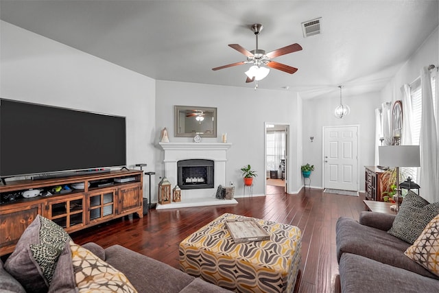 living room with dark wood-type flooring and ceiling fan