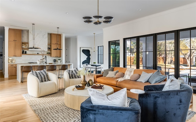 living room featuring crown molding and light hardwood / wood-style floors