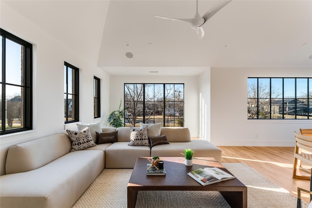 living room with hardwood / wood-style flooring, ceiling fan, and a wealth of natural light