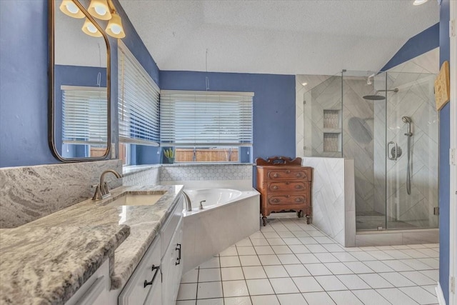 bathroom featuring plus walk in shower, lofted ceiling, vanity, tile patterned floors, and a textured ceiling