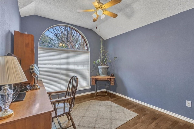 home office with hardwood / wood-style flooring, vaulted ceiling, and a textured ceiling