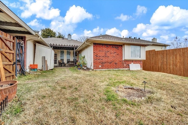 rear view of house with a lawn